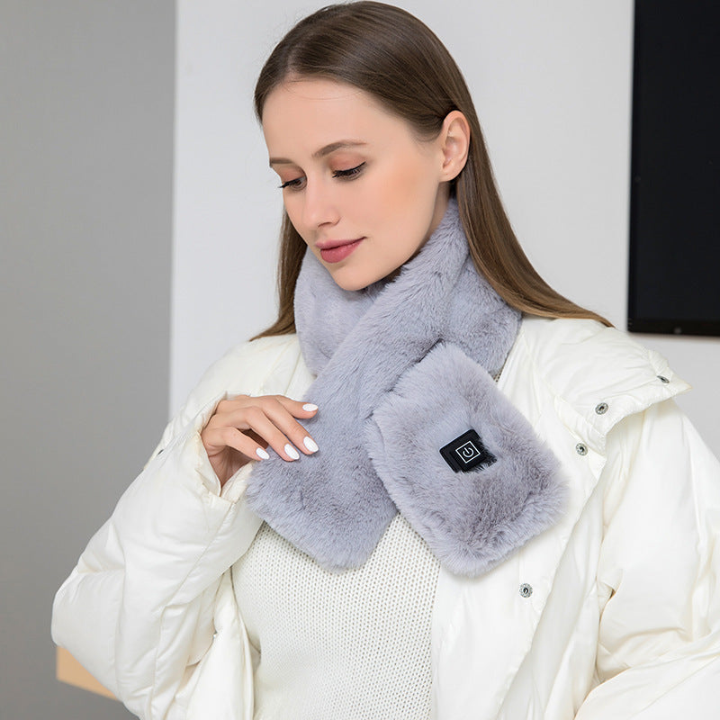 Woman wearing the gray faux fur USB heated scarf over a white winter jacket
