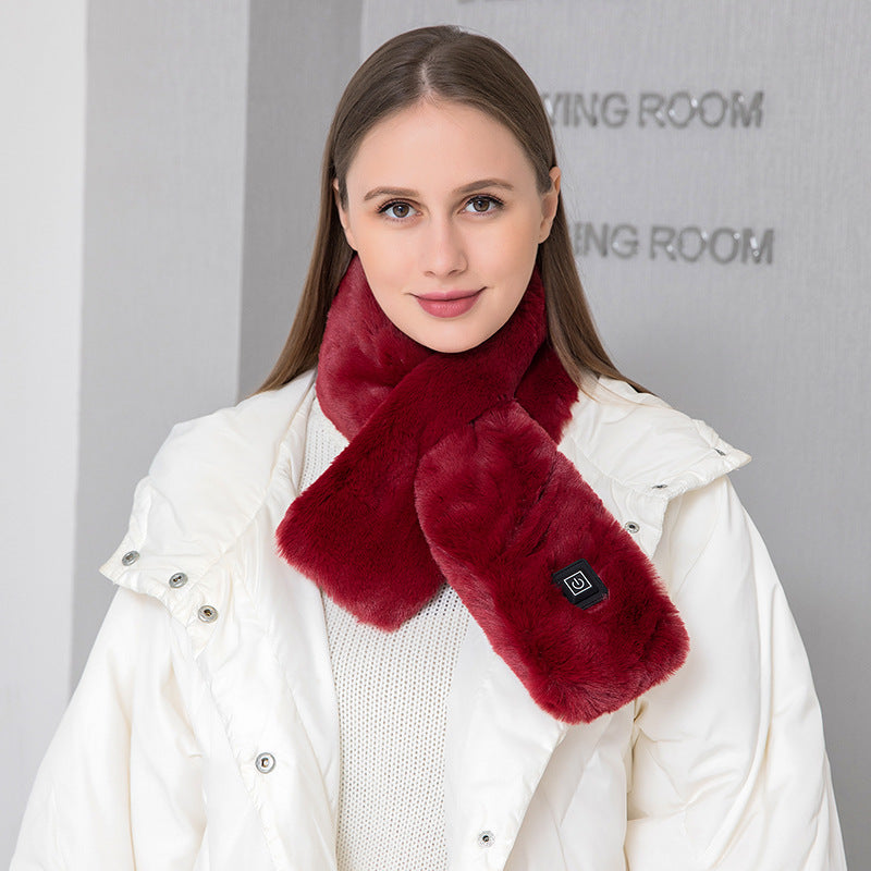 Woman wearing the wine red faux fur USB heated scarf over a white winter jacket
